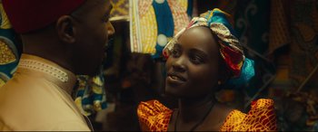 Movie still from “Queen of Katwe” (2016), directed by Mira Nair – A woman wearing a head scarf talking to a man; Close Up shot, Over the shoulder angle