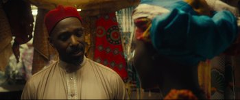 Movie still from “Queen of Katwe” (2016), directed by Mira Nair – A man and a woman talking in front of a window; Close Up shot, Over the shoulder angle