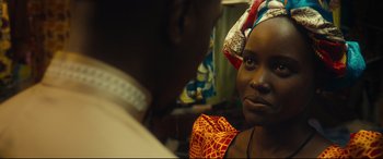 Movie still from “Queen of Katwe” (2016), directed by Mira Nair – A person wearing a head scarf; Close Up shot, Over the shoulder angle