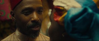 Movie still from “Queen of Katwe” (2016), directed by Mira Nair – A person with a beard; Close Up shot, Over the shoulder angle