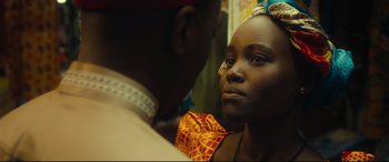 Movie still from “Queen of Katwe” (2016), directed by Mira Nair – A man and a woman looking into each other's eyes; Close Up shot, Over the shoulder angle