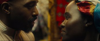 Movie still from “Queen of Katwe” (2016), directed by Mira Nair – A man and a woman face to face in a room; Close Up shot, Over the shoulder angle