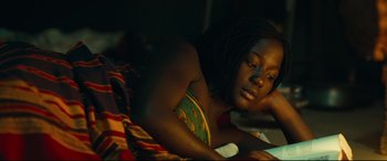 Movie still from “Queen of Katwe” (2016), directed by Mira Nair – A woman laying in bed with her head on her pillow; Close Up shot, High angle