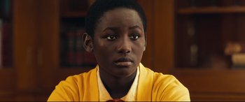 Movie still from “Queen of Katwe” (2016), directed by Mira Nair – A person wearing a shirt and tie; Close Up shot, High angle