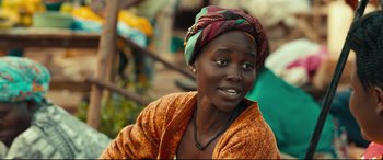 Movie still from “Queen of Katwe” (2016), directed by Mira Nair – A person wearing a head scarf; Close Up shot, Over the shoulder angle