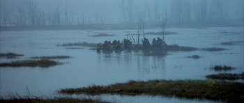 Movie still from “Quest for Fire” (1981), directed by Jean-Jacques Annaud – A herd of animals in a body of water; Extreme Wide shot, High angle