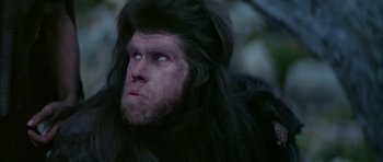 Movie still from “Quest for Fire” (1981), directed by Jean-Jacques Annaud – A person wearing a gorilla costume; Close Up shot, Low angle