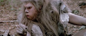 Movie still from “Quest for Fire” (1981), directed by Jean-Jacques Annaud – A person with long hair; Close Up shot, Low angle