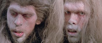Movie still from “Quest for Fire” (1981), directed by Jean-Jacques Annaud – Two people with long hair and white face paint; Close Up shot, Low angle