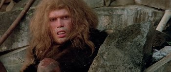 Movie still from “Quest for Fire” (1981), directed by Jean-Jacques Annaud – A person with a long hair; Close Up shot, Low angle