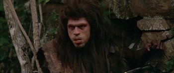 Movie still from “Quest for Fire” (1981), directed by Jean-Jacques Annaud – A person with a long hair; Close Up shot, Low angle