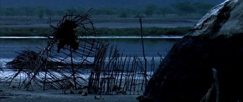 Movie still from “Quest for Fire” (1981), directed by Jean-Jacques Annaud – A body of water surrounded by tall grass; Extreme Wide shot, Low angle