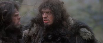 Movie still from “Quest for Fire” (1981), directed by Jean-Jacques Annaud – A person wearing a fur coat; Close Up shot, Low angle