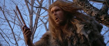 Movie still from “Quest for Fire” (1981), directed by Jean-Jacques Annaud – A person with long hair; Close Up shot, Low angle