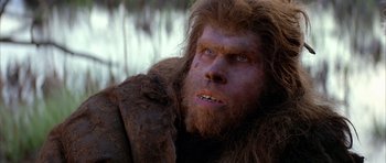 Movie still from “Quest for Fire” (1981), directed by Jean-Jacques Annaud – A person with a hairy face; Close Up shot, Low angle