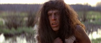 Movie still from “Quest for Fire” (1981), directed by Jean-Jacques Annaud – A person with a long hair; Close Up shot, Low angle