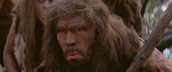 Movie still from “Quest for Fire” (1981), directed by Jean-Jacques Annaud – A person with a hairy face; Close Up shot, Low angle