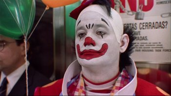 Movie still from “Quick Change” (1990), directed by Howard Franklin – A man with a clown make - up on his face; Close Up shot, Low angle