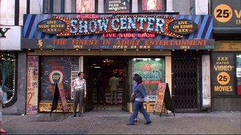 Movie still from “Quick Change” (1990), directed by Howard Franklin – Two women walking in front of a store front; Wide shot, Low angle