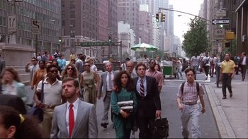 Movie still from “Quick Change” (1990), directed by Howard Franklin – A group of people walking across a street; Wide shot, Low angle