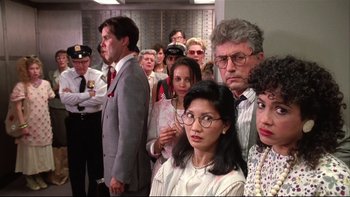 Movie still from “Quick Change” (1990), directed by Howard Franklin – A group of people standing in a room; Medium shot, Low angle