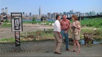 Movie still from “Quick Change” (1990), directed by Howard Franklin – Three men and a woman standing on the side of the road; Wide shot, Low angle