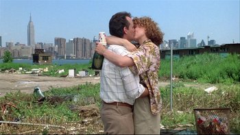 Movie still from “Quick Change” (1990), directed by Howard Franklin – A man and a woman kissing in front of a city skyline; Medium shot, Low angle