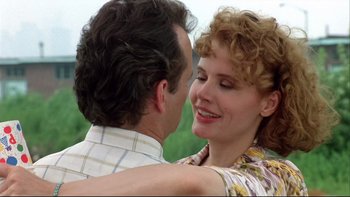 Movie still from “Quick Change” (1990), directed by Howard Franklin – A man and a woman embracing each other outside; Close Up shot, Low angle