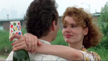 Movie still from “Quick Change” (1990), directed by Howard Franklin – A man and a woman are hugging each other outside; Close Up shot, Low angle