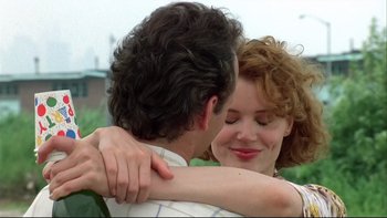 Movie still from “Quick Change” (1990), directed by Howard Franklin – A man and a woman embracing each other; Close Up shot, Low angle