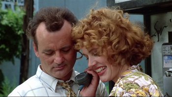 Movie still from “Quick Change” (1990), directed by Howard Franklin – A man and a woman are talking on a phone; Close Up shot, Low angle
