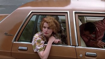Movie still from “Quick Change” (1990), directed by Howard Franklin – A woman leaning out of the window of a car; Close Up shot, Low angle