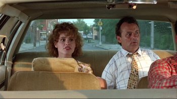 Movie still from “Quick Change” (1990), directed by Howard Franklin – A man and a woman sitting in the back seat of a car; Medium shot, Over the shoulder angle