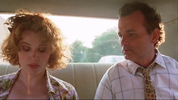 Movie still from “Quick Change” (1990), directed by Howard Franklin – A man and a woman sitting in the back of a car; Close Up shot, Low angle