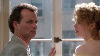 Movie still from “Quick Change” (1990), directed by Howard Franklin – A man and a woman standing next to each other in front of an open window; Close Up shot, Over the shoulder angle