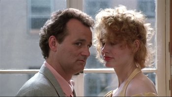 Movie still from “Quick Change” (1990), directed by Howard Franklin – A man and a woman standing next to each other in front of a window; Close Up shot, Low angle