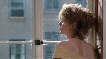 Movie still from “Quick Change” (1990), directed by Howard Franklin – A woman with curly hair looking out of a window; Close Up shot, Low angle