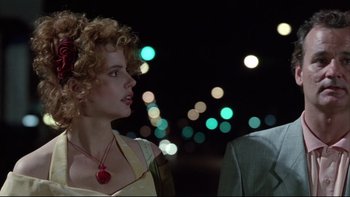 Movie still from “Quick Change” (1990), directed by Howard Franklin – A woman with curly red hair wearing a red necklace; Close Up shot, Low angle