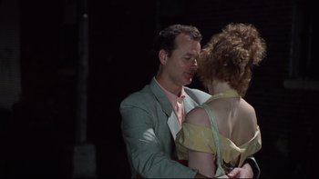 Movie still from “Quick Change” (1990), directed by Howard Franklin – A man and a woman are dancing together in the dark; Close Up shot, Low angle