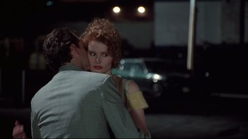 Movie still from “Quick Change” (1990), directed by Howard Franklin – A man and a woman hugging on the street; Close Up shot, Over the shoulder angle