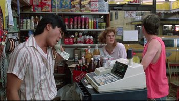 Movie still from “Quick Change” (1990), directed by Howard Franklin – A man and a woman at a cash register in a convenience store; Medium shot, Low angle