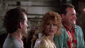Movie still from “Quick Change” (1990), directed by Howard Franklin – A group of people standing next to each other in a room; Close Up shot, Over the shoulder angle