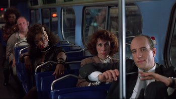 Movie still from “Quick Change” (1990), directed by Howard Franklin – A group of people riding on a bus; Medium shot, Low angle