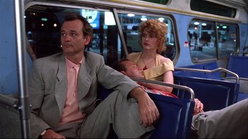 Movie still from “Quick Change” (1990), directed by Howard Franklin – A man and a woman sitting next to each other on a bus; Medium shot, Low angle