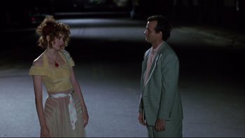 Movie still from “Quick Change” (1990), directed by Howard Franklin – A man and a woman standing next to each other in a parking lot; Medium shot, Over the shoulder angle