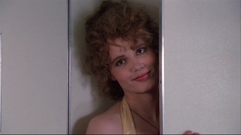 Movie still from “Quick Change” (1990), directed by Howard Franklin – A person with curly hair in a room; Close Up shot, Low angle