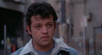 Movie still from “Quicksilver” (1986), directed by Thomas Michael Donnelly – A person wearing a jacket; Close Up shot, Low angle