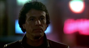 Movie still from “Quicksilver” (1986), directed by Thomas Michael Donnelly – A person wearing a leather jacket; Close Up shot, Low angle