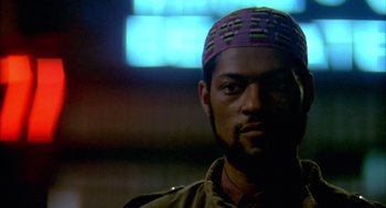 Movie still from “Quicksilver” (1986), directed by Thomas Michael Donnelly – A person wearing a hat; Close Up shot, Low angle