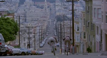 Movie still from “Quicksilver” (1986), directed by Thomas Michael Donnelly – Two people on bikes riding down a steep hill; Extreme Wide shot, Low angle